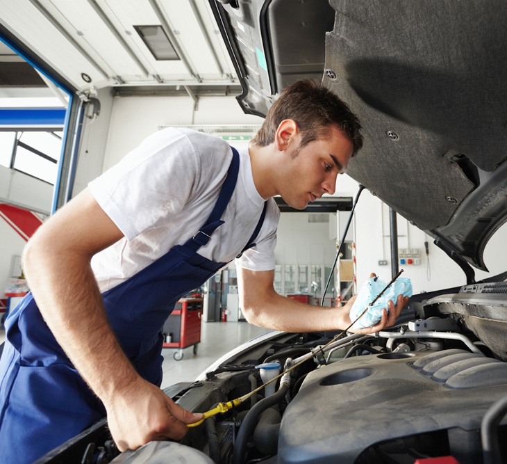 Car Mechanic Checking Oil